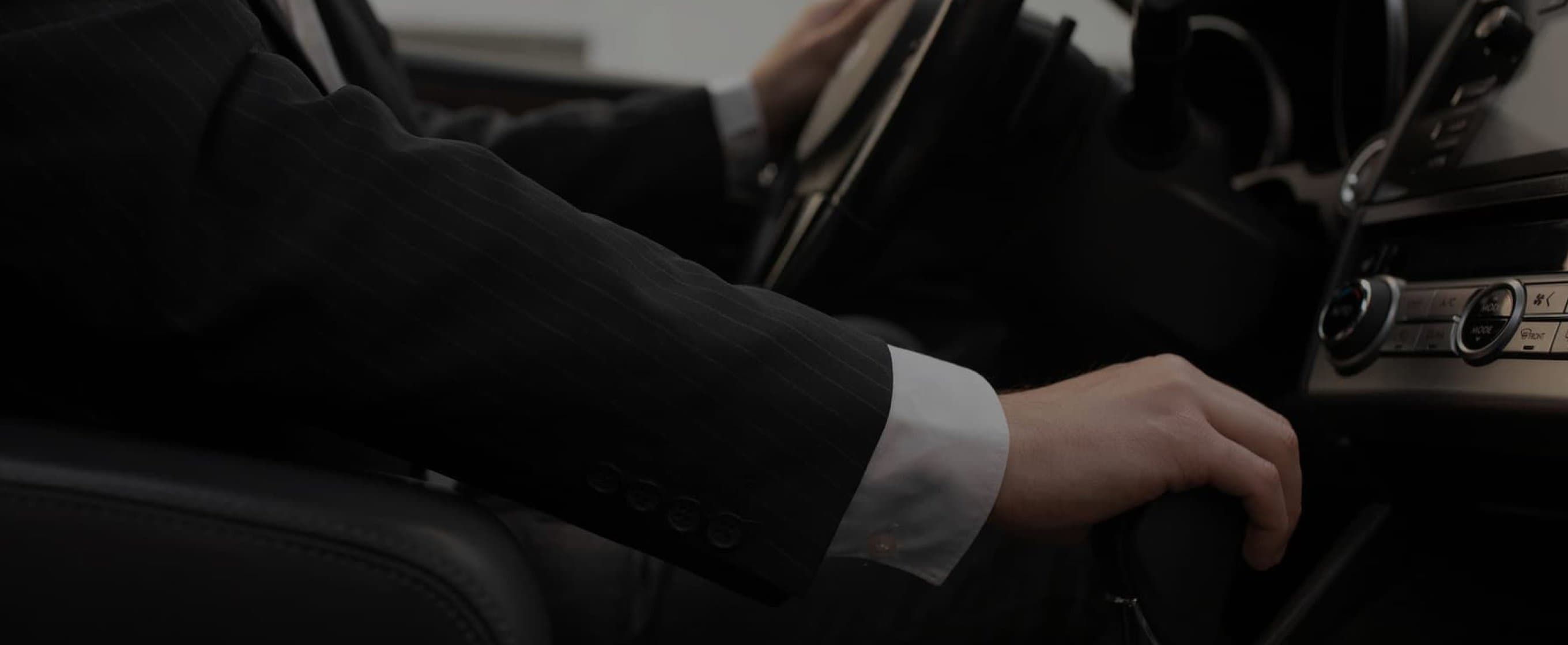 A chauffeur's hand on the gear shift