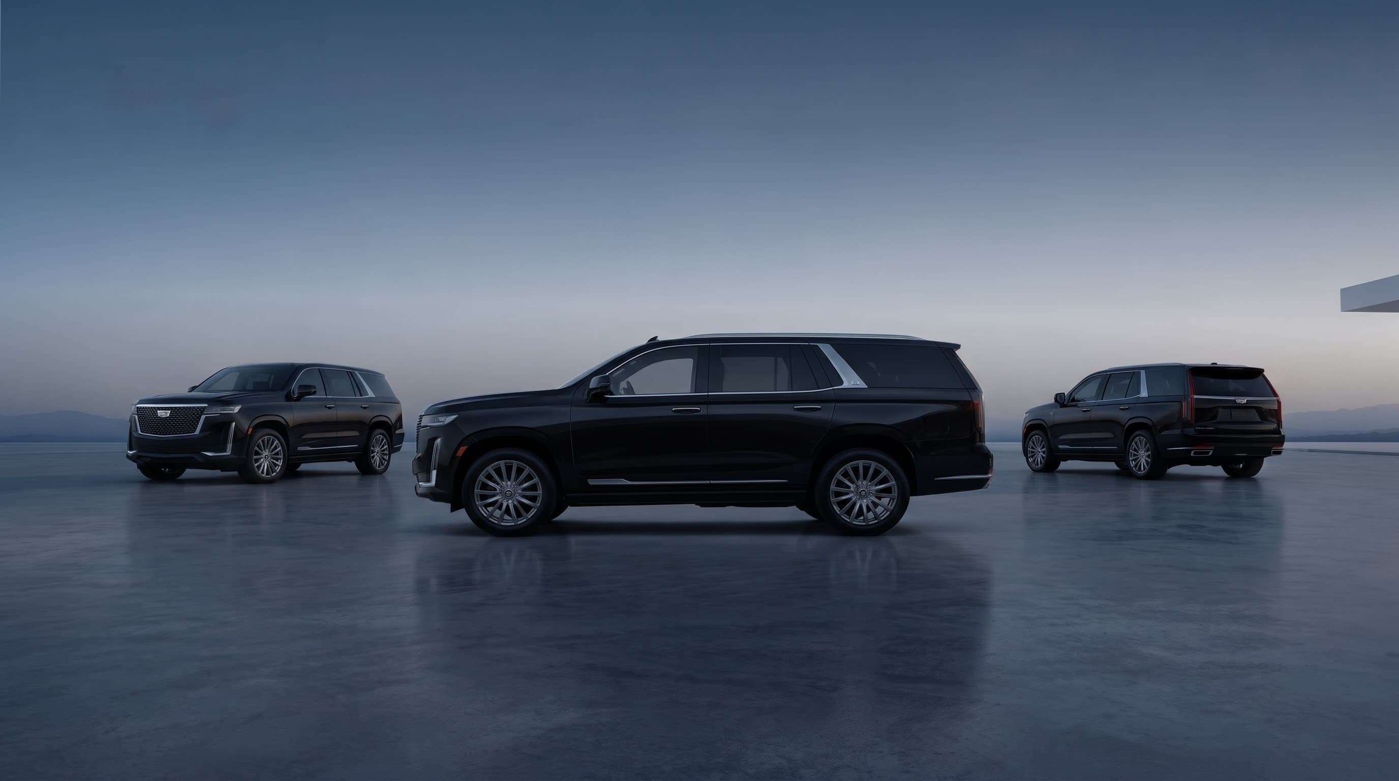 Three black luxury SUVs parked in a modern showroom