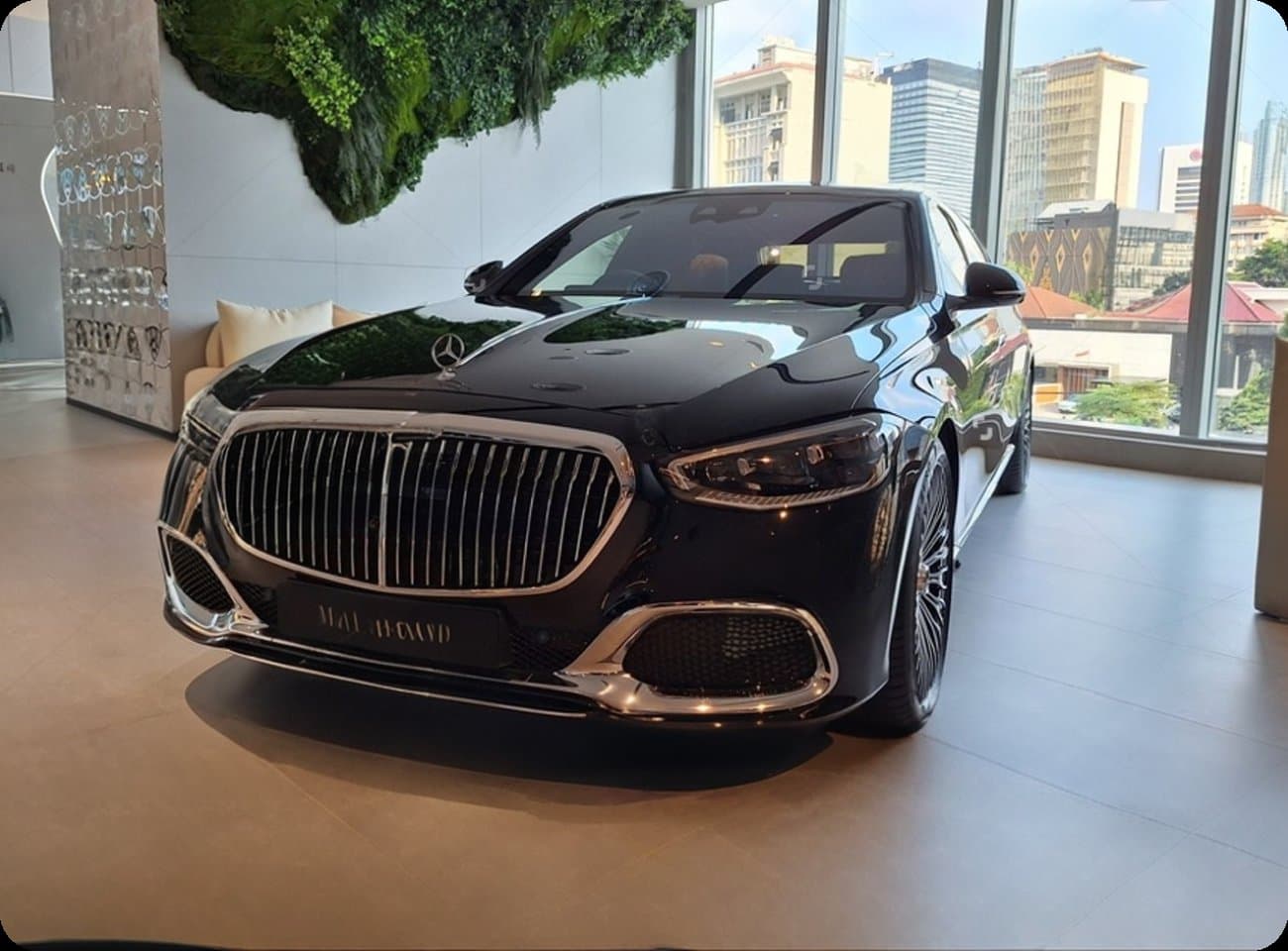 A black luxury sedan in a bright modern lobby