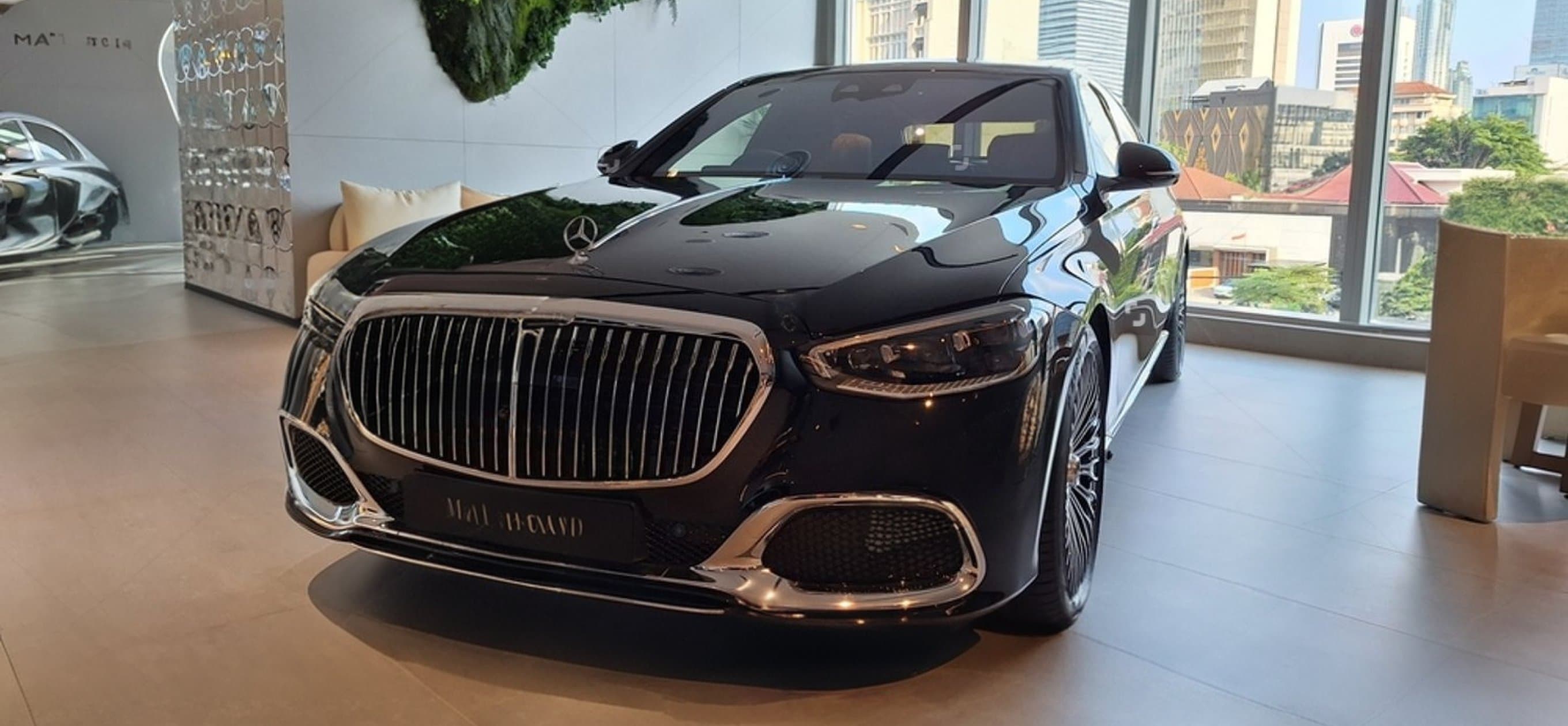 A black luxury sedan in a bright modern lobby